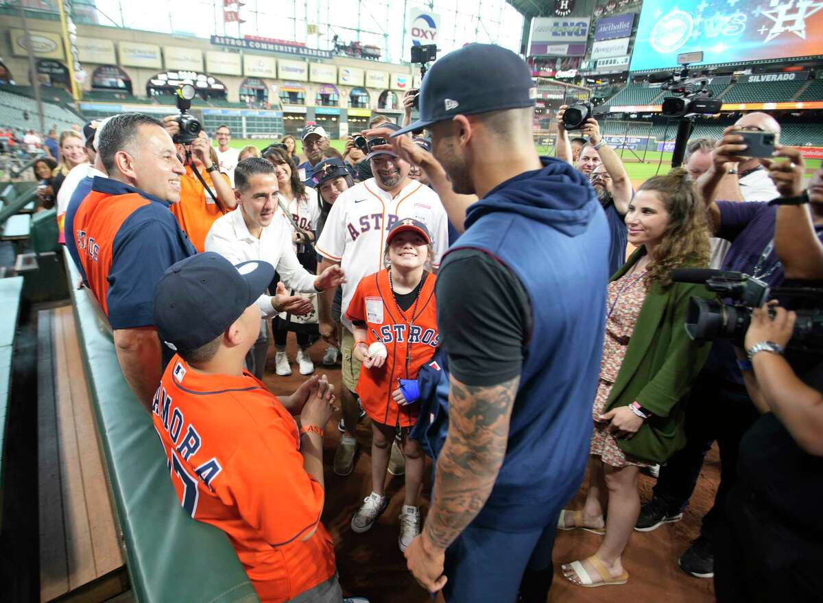 Carlos Correa greets 10-year-old Uvalde Survivor Mayah Zamora and her family during batting practice before the start of an MLB baseball game at Minute Maid Park on Tuesday, Aug. 23, 2022 in Houston.