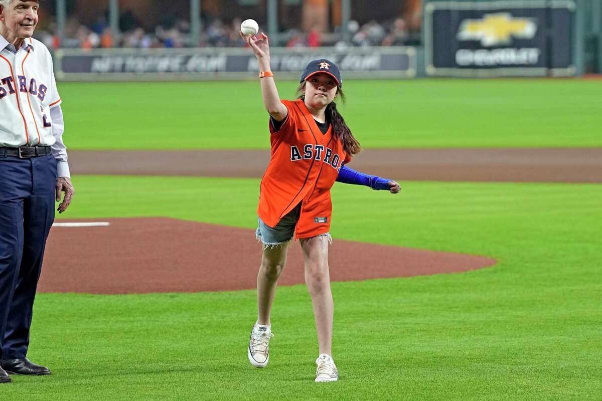 Mayah Zamora, a survivor of the school shooting at Robb Elementary in Uvalde, Texas, throws out a ceremonial first pitch before a baseball game between the Minnesota Twins and Houston Astros Tuesday, Aug. 23, 2022, in Houston. (AP Photo/David J. Phillip)