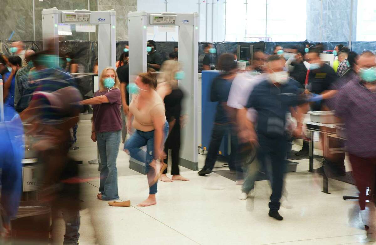 People go through security as they enter the Harris County Criminal Justice Center on Sunday, Aug. 14, 2022 in Houston.