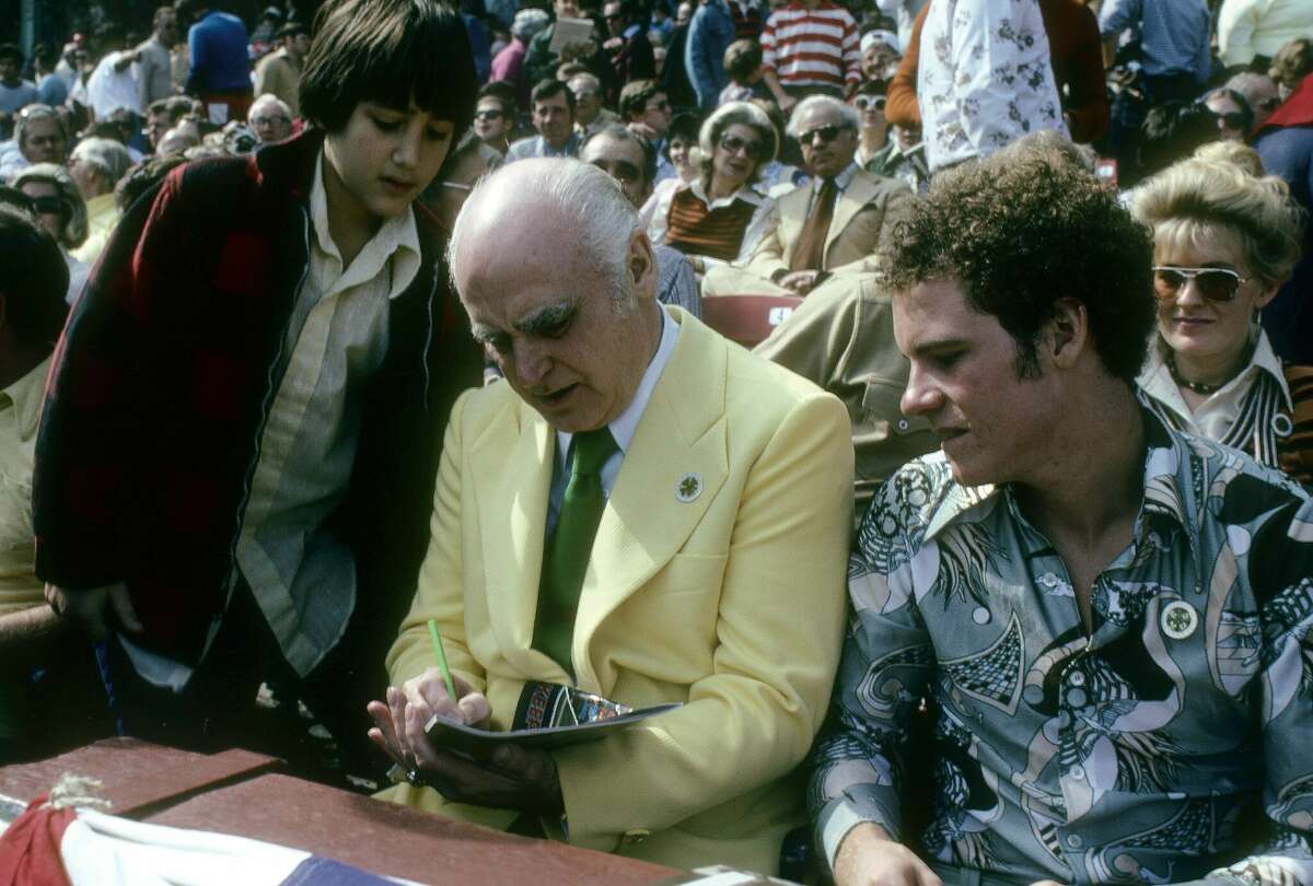 Owner Charlie Finley of the Oakland Athletics signs an autograph prior to the start of a MLB baseball game circa mid 1970's. Finley owned the Athletics from 1960-80.