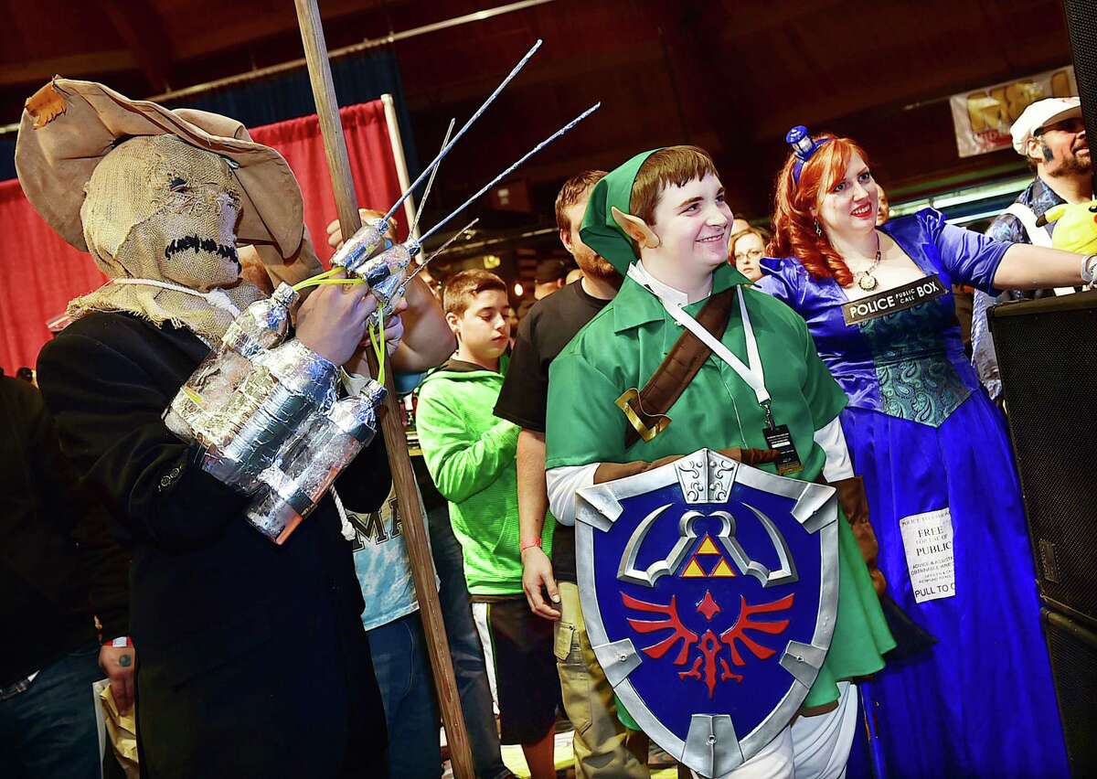 Bethel resident Ben Webb as the Scarecrow from Arkham Asylum and Fairfield resident Ian Konigsbert, dressed as Linkfrom the Legend of Zelda watch judges tabulate the scores Saturday, October 3, 2015, at the RetroWorld Expo at the Oakdale Theater in Wallingford. Konigsberg won the costume contest with Webb coming in second. 
