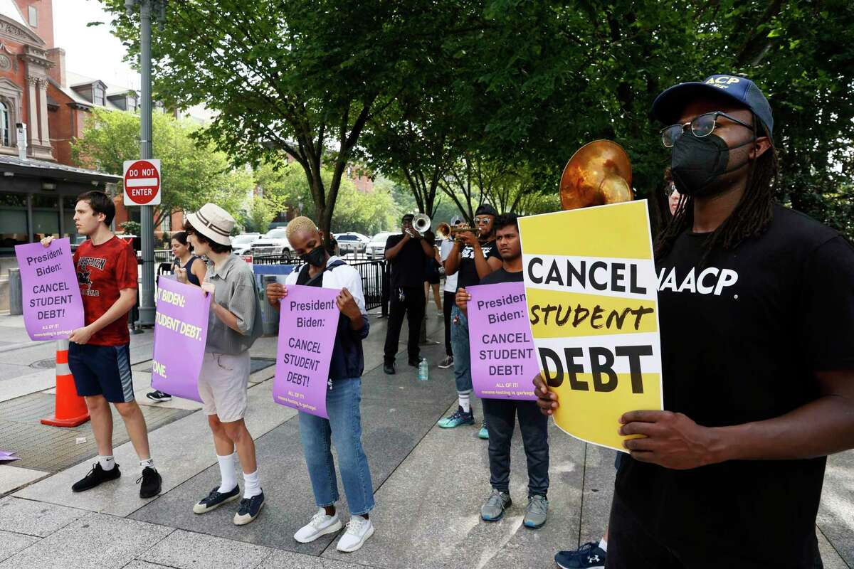 Student loan debt holders take part in a demonstration outside of the white house staff entrance to demand that President Biden cancel student loan debt in August on July 27, 2022 at the Executive Offices in Washington, DC.