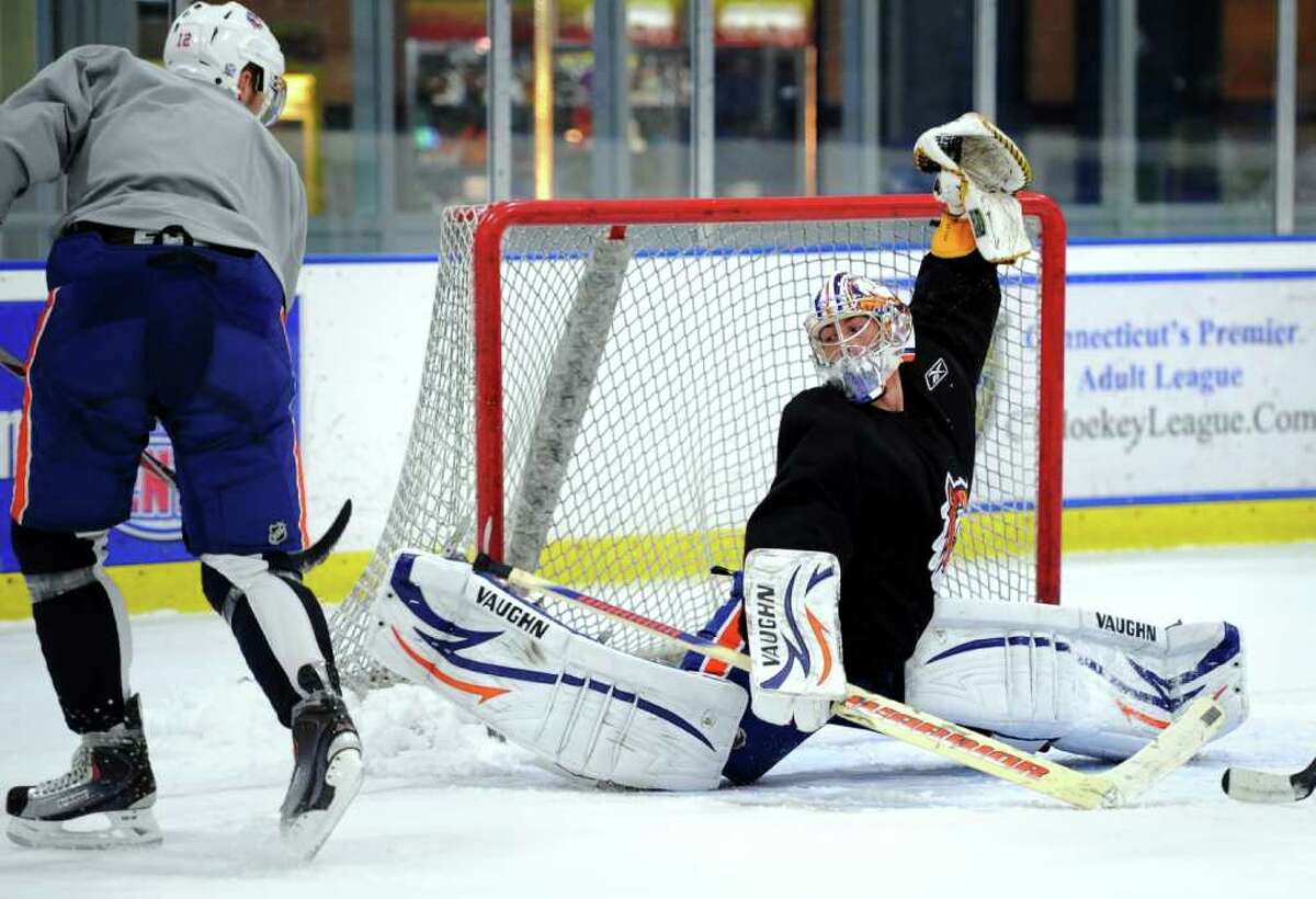 Goalie Kevin Poulin reaches to block a shot during Sound Tigers practice Wednesday Oct. 6, 2010 at The Rinks at SportsCenter of Connecticut in Shelton.
