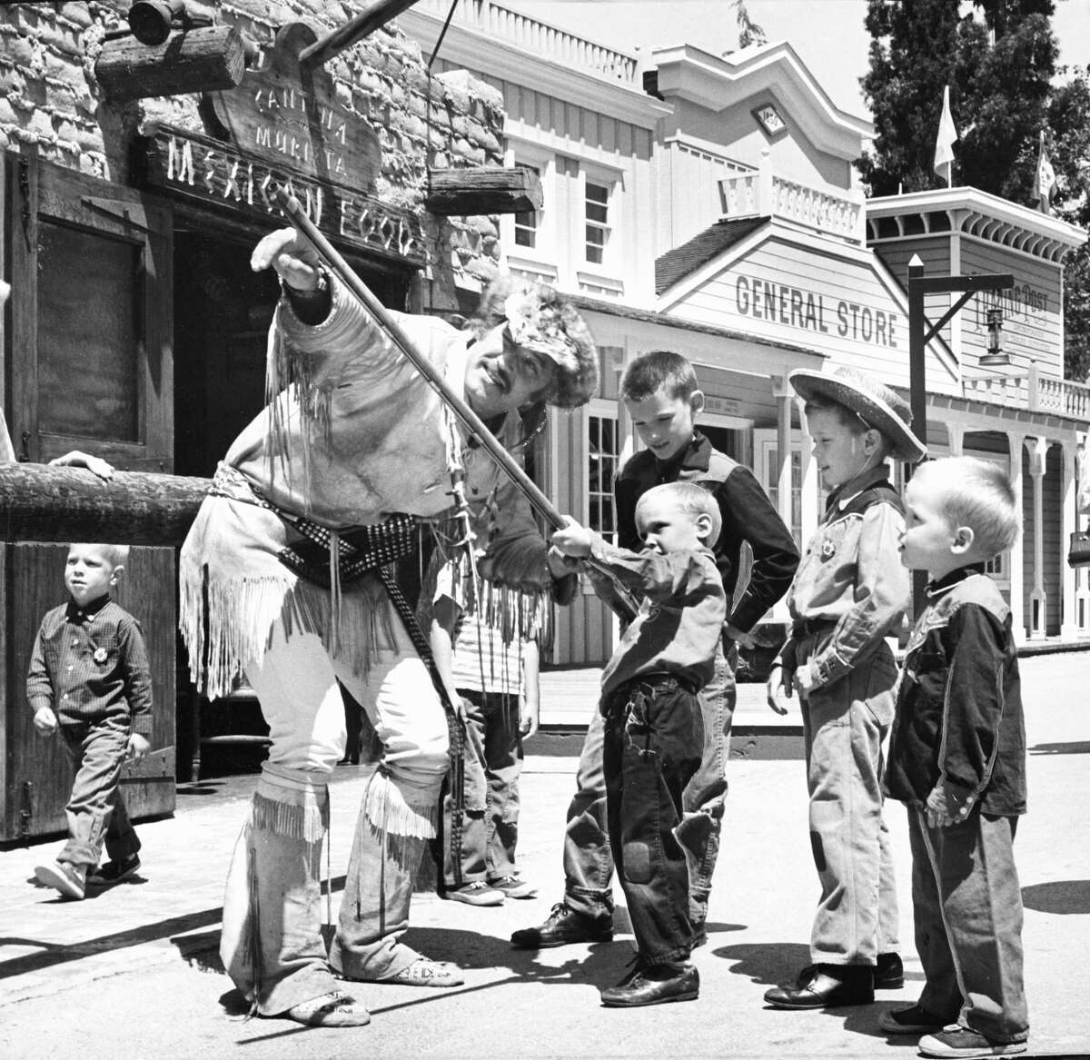 Children play with a rifle at Frontier Village, an amusement park that operated from 1961 to 1980 in San Jose.