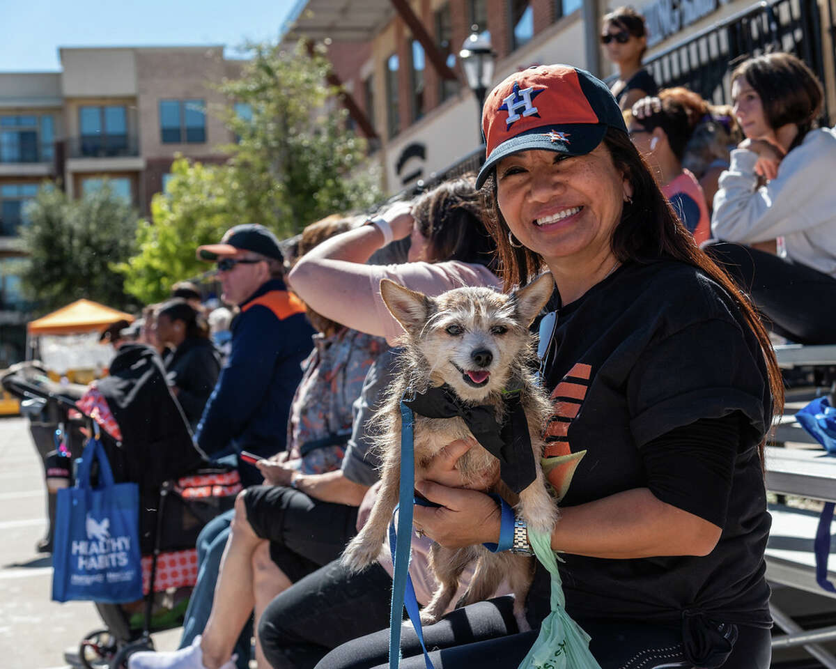 A Paws Fest 2021 visitor and her pup watch the Dock Dogs competition in LaCenterra.