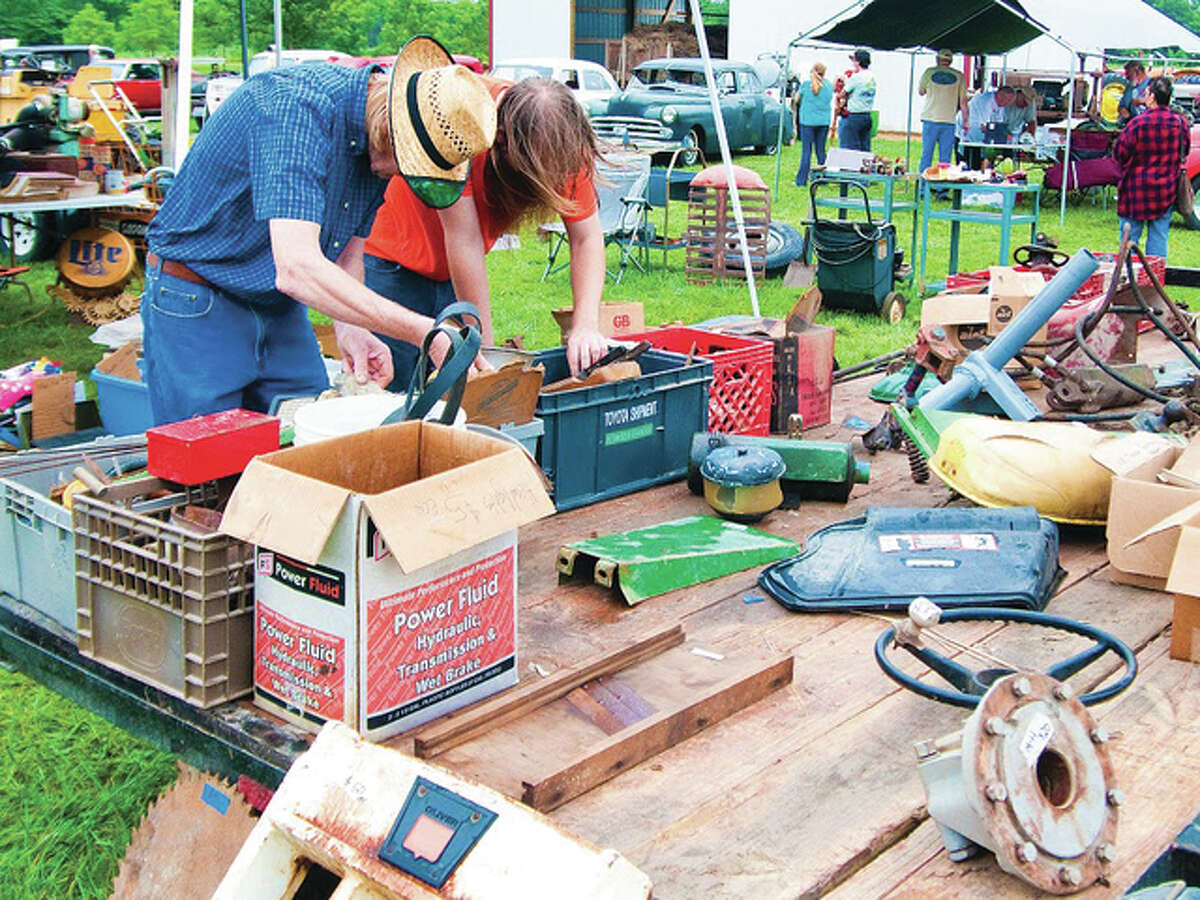 Louis Taylor, left, and his son, Brandon, look for old tools and tractor parts during the silver anniversary of the Tri-County Antique Club’s Olden Days Festival in Dow in 2015.  The Tri-County Antique Club will showcase antiques and history at the 31st annual "Olden Days" festival Aug. 27 and 28 at 23946 State Highway 3 in Dow. The festival will begin at 7 a,m, Saturday, Aug. 27.