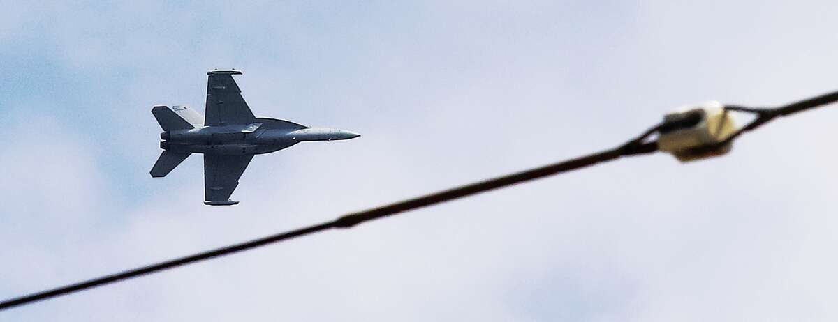 John Badman|The Telegraph The sight of an F-18 Hornet fighter jet, seen here circling Wood River, turned heads upwards Thursday before it landed at St. Louis Regional Airport in Bethalto.