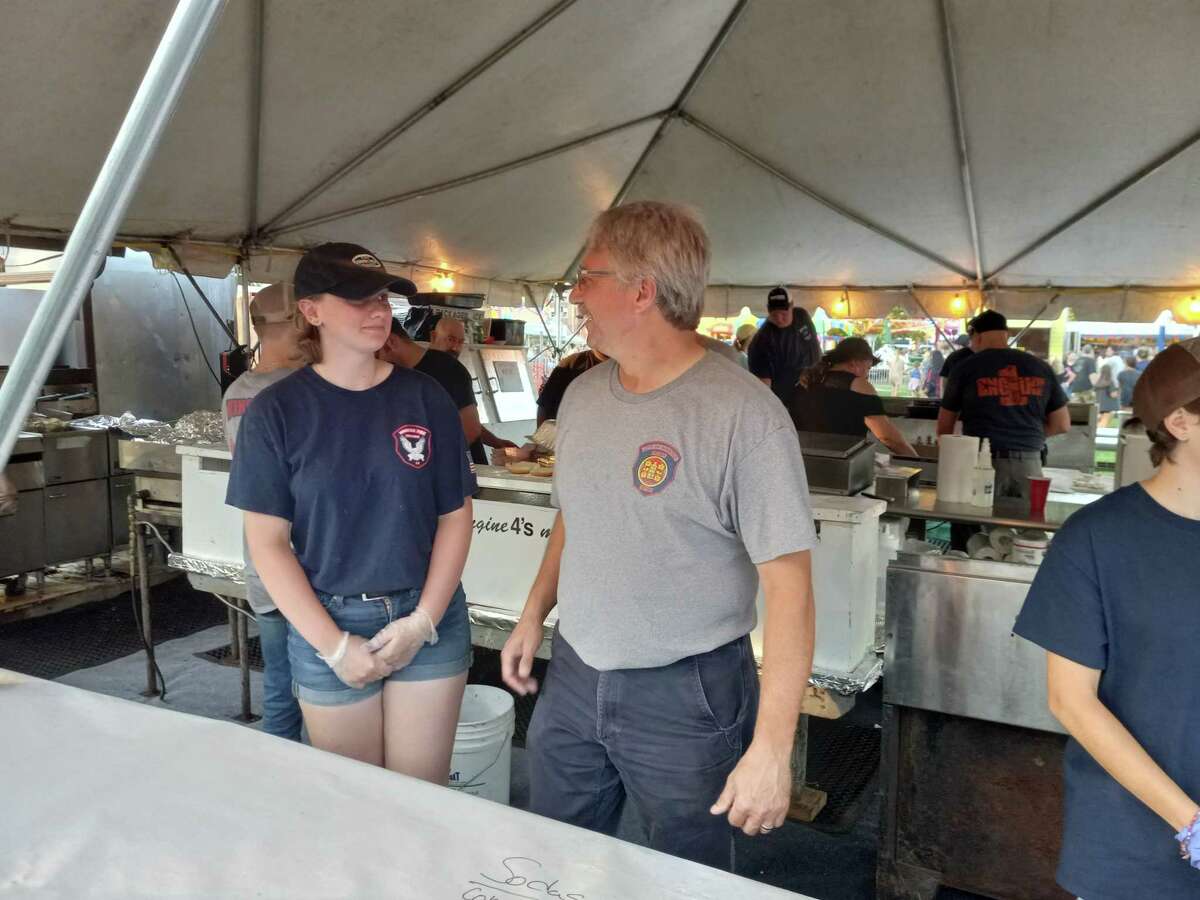 The Winsted Fire Department's annual carnival kicked off Aug. 24 at Rowley Field. The event continues through Saturday, Aug. 27. Pictured is Fire Chief Jamie Lagasse and volunteer Linnea Ludwig.