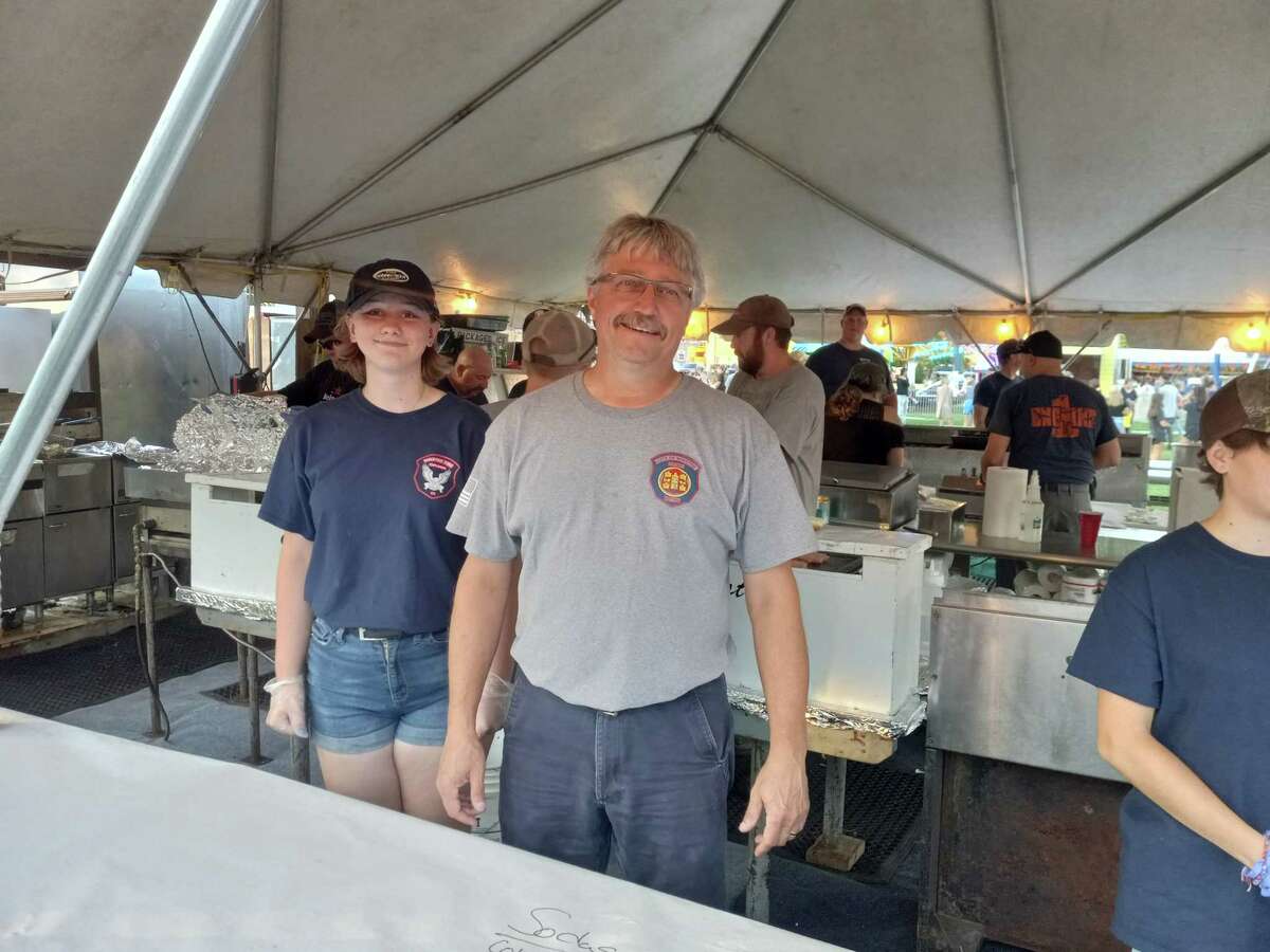 The Winsted Fire Department's annual carnival kicked off Aug. 24 at Rowley Field. The event continues through Saturday, Aug. 27. Pictured is Fire Chief Jamie Lagasse and volunteer Linnea Ludwig.