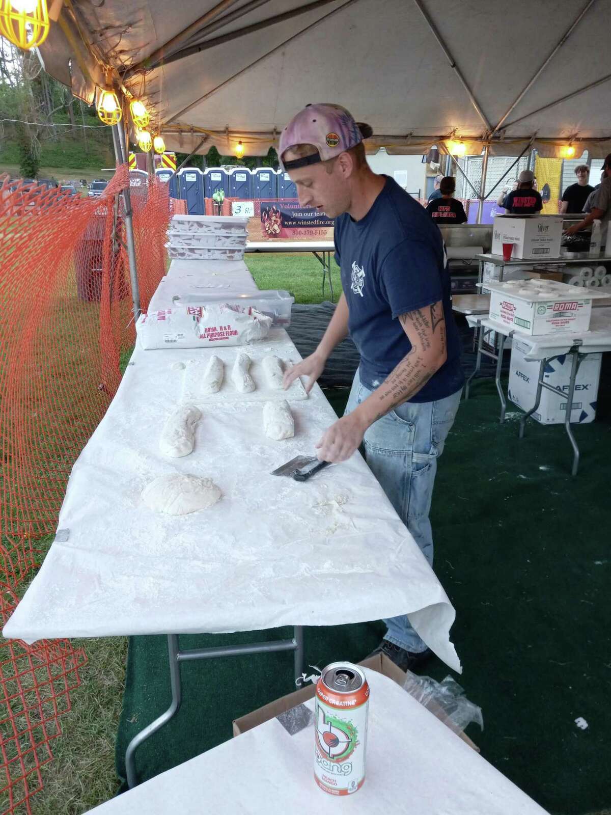 The Winsted Fire Department’s annual carnival kicked off Aug. 24 at Rowley Field. The event continues through Saturday, Aug. 27. Fire Department member Mike Buttrick cuts pieces for fried dough at the WFD booth.