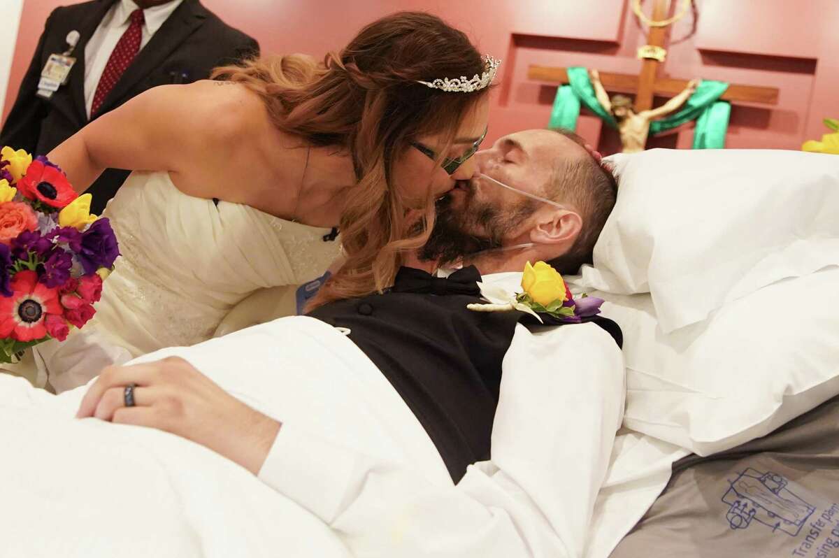 Noah Lathrop and Jade Barba kiss after their wedding at the chapel at Baylor St. Luke’s hospital on Wednesday, Aug. 24, 2022 in Houston. Lathrop, 40, who has advance colon cancer, wished that two could be married before he died. The couple, with the help of hospital staff and loads of volunteers, put the wedding together in 48 hours.