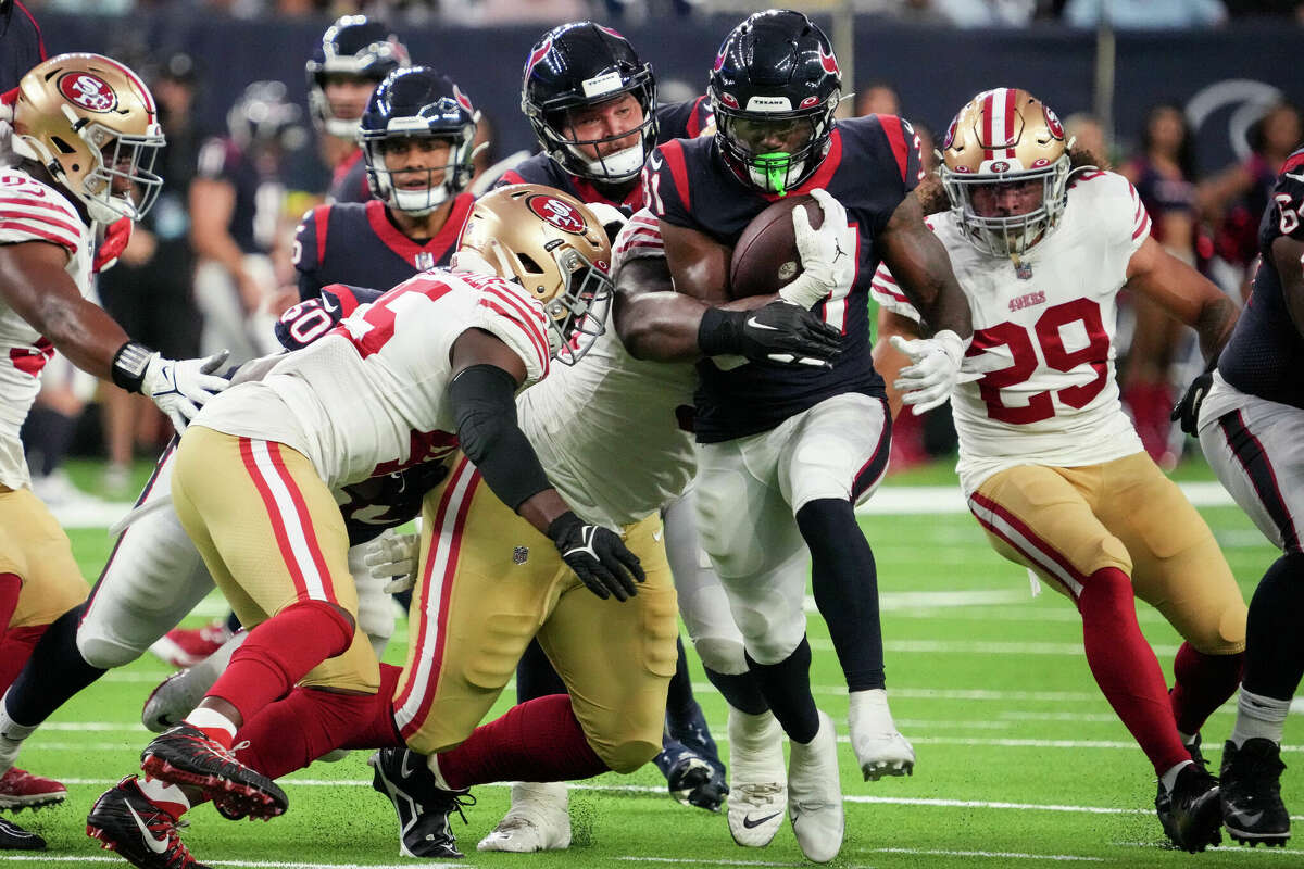 Houston Texans running back Dameon Pierce (31) runs through the middle of the San Francisco 49ers defense during the first half of an NFL football game Thursday, Aug. 25, 2022, in Houston.