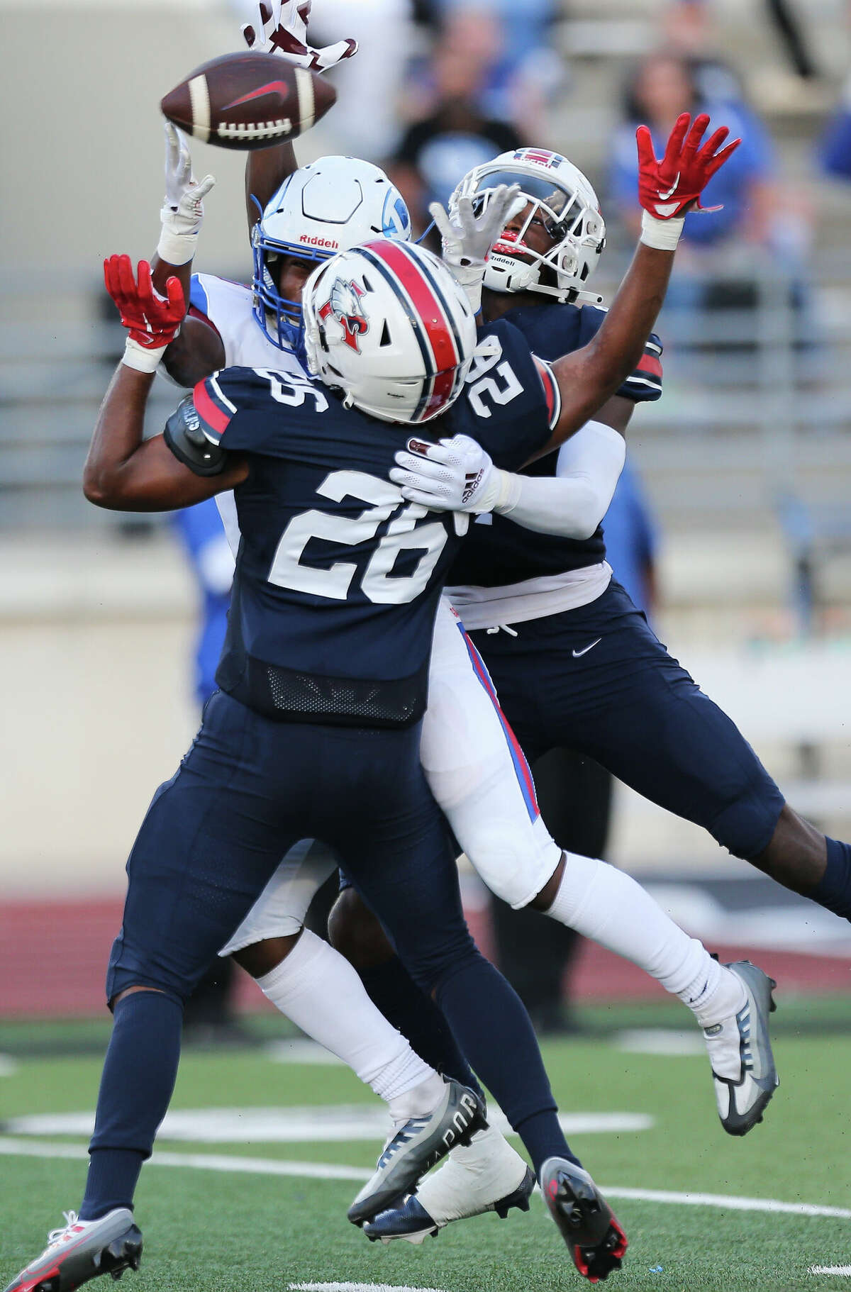Atascocita players Chace Willis (26) and Braylon Conley (4) team up to interrupt an intended pass to Dickinson wide receiver De'Rion Crooms during the first quarter of a non-district game Thursday, Aug. 25, 2022, at Turner Stadium in Humble.