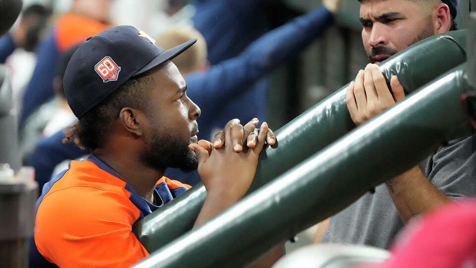 Houston Astros pitcher Cristian Javier in the dugout with Jose Urquidy during the third inning of an MLB baseball game at Minute Maid Park on Thursday, Aug. 25, 2022 in Houston.