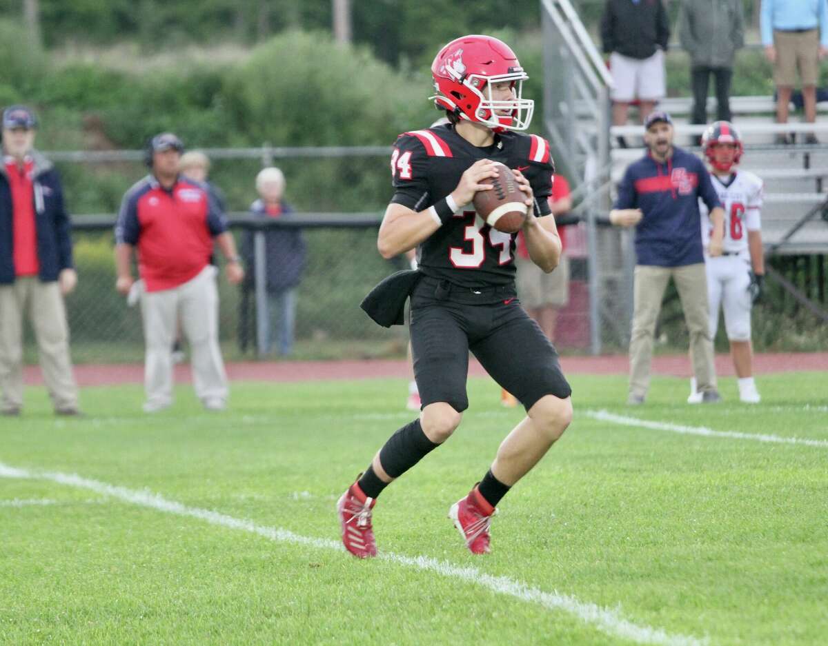 Benzie Central's Dan Wallington drops back for a pass during his first varsity football game under center. 