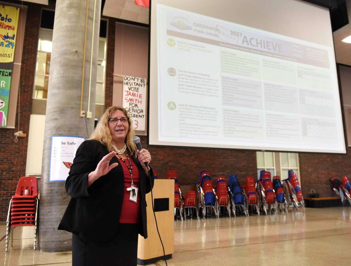 Greenwich Public Schools Superintendent Toni Jones speaks at the New Teacher Orientation at Greenwich High School in Greenwich, Conn. Wednesday, Aug. 24, 2022. She presented a draft of a strategic plan for the district on the screen behind her.