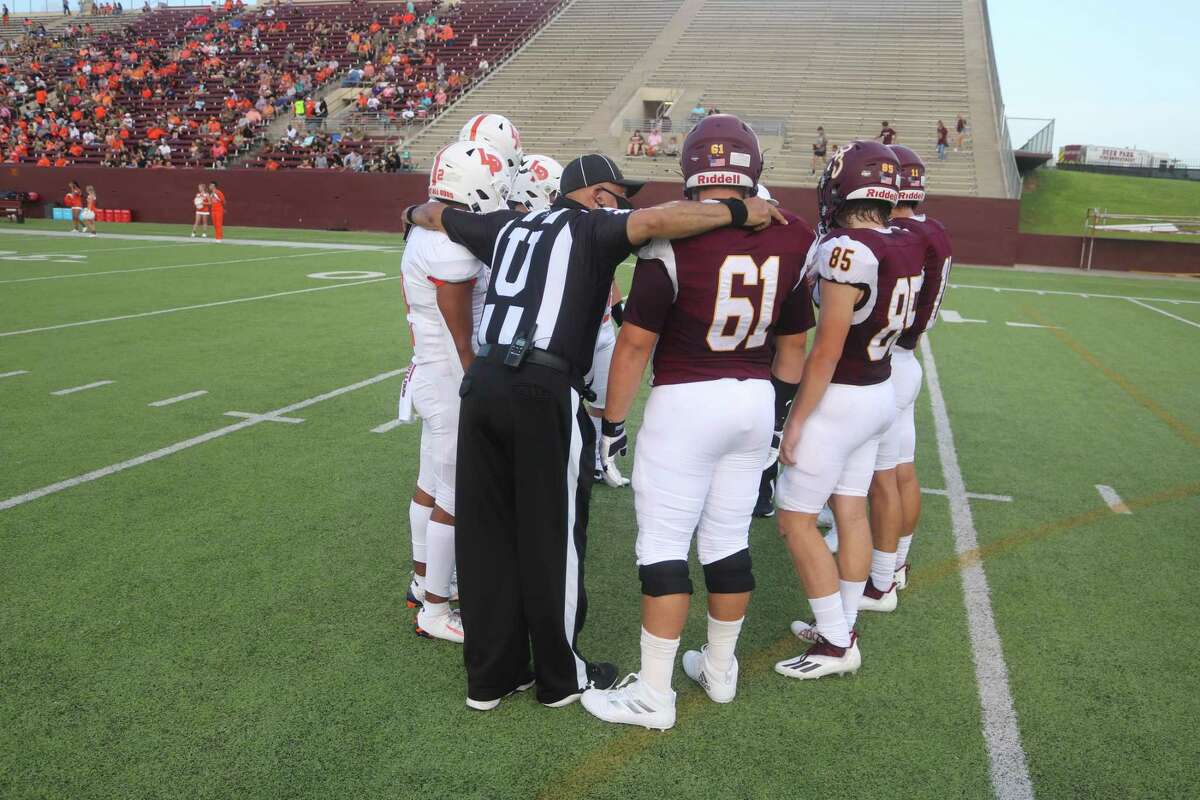A referee is likely reminding Deer Park and La Porte players that 15-yard infractions routinely derail drives and to stay away from them during the 2021 game.
