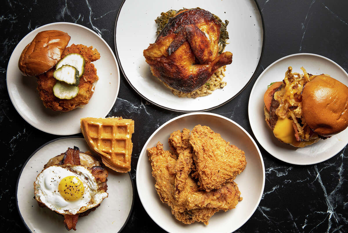 Assorted dishes from Craft Burger and Pecking Order, a new chicken concept from Craft Burger owner, opening in October at Finn Hall food hall in downtown Houston.