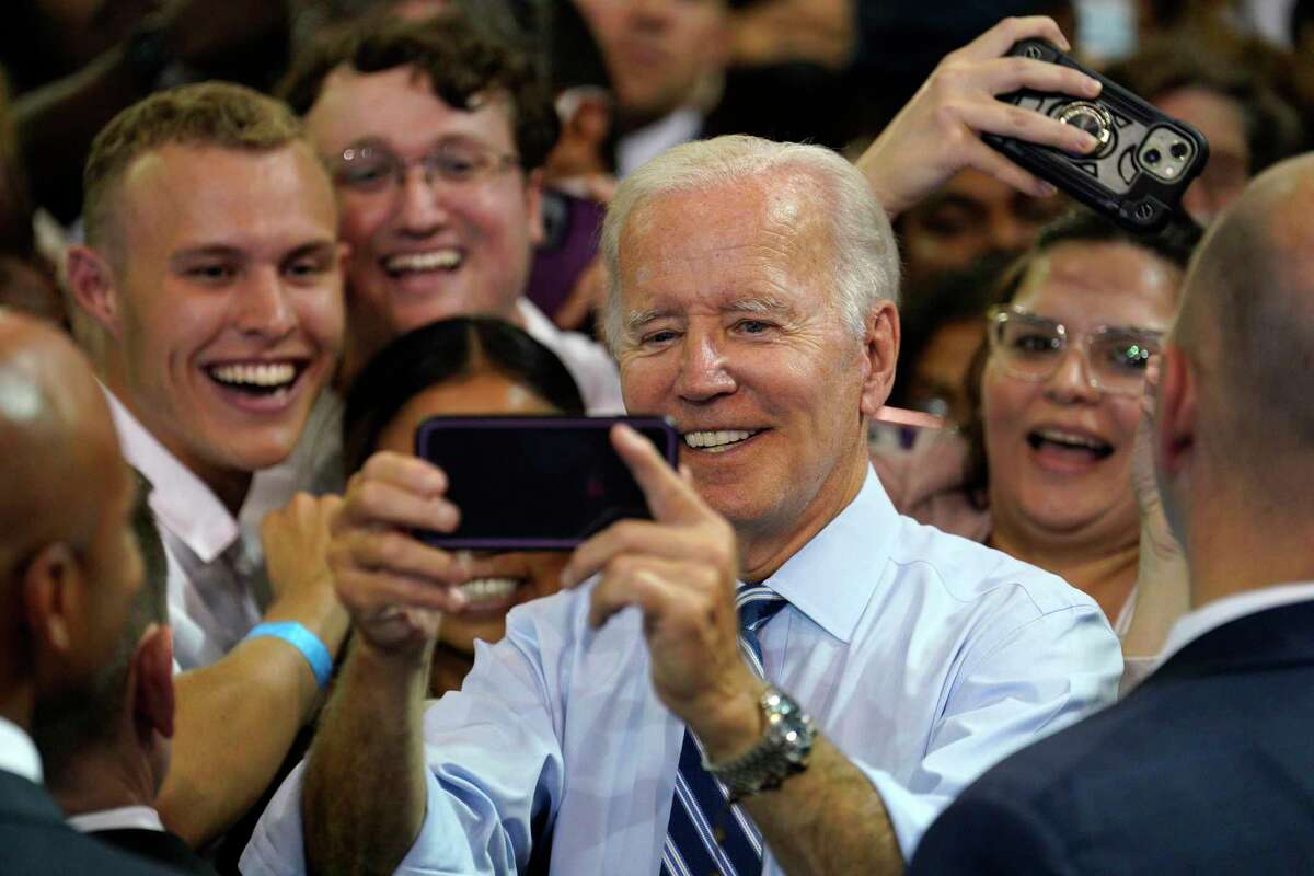 President Joe Biden poses for selfie with supporters at a rally for the Democratic National Committee at Richard Montgomery High School on Thursday, Aug. 25, 2022, in Rockville, Maryland. (Yuri Gripas/Abaca Press/TNS)