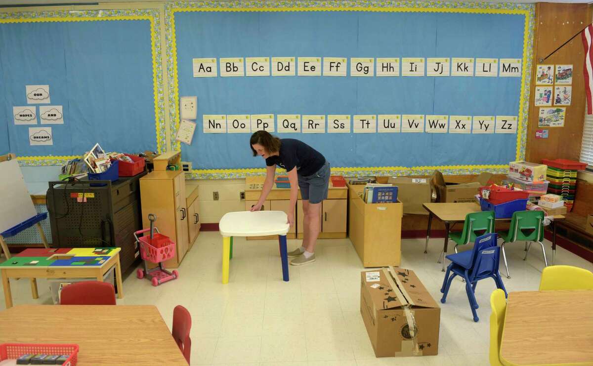 Kindergarten teacher Heather Hearty arranges a kitchen her classroom during Setup Day at Farmingville Elementary School, in Ridgefield, Conn. Teachers were in school to setup their classrooms for the new school year. Tuesday, August 23, 2022.