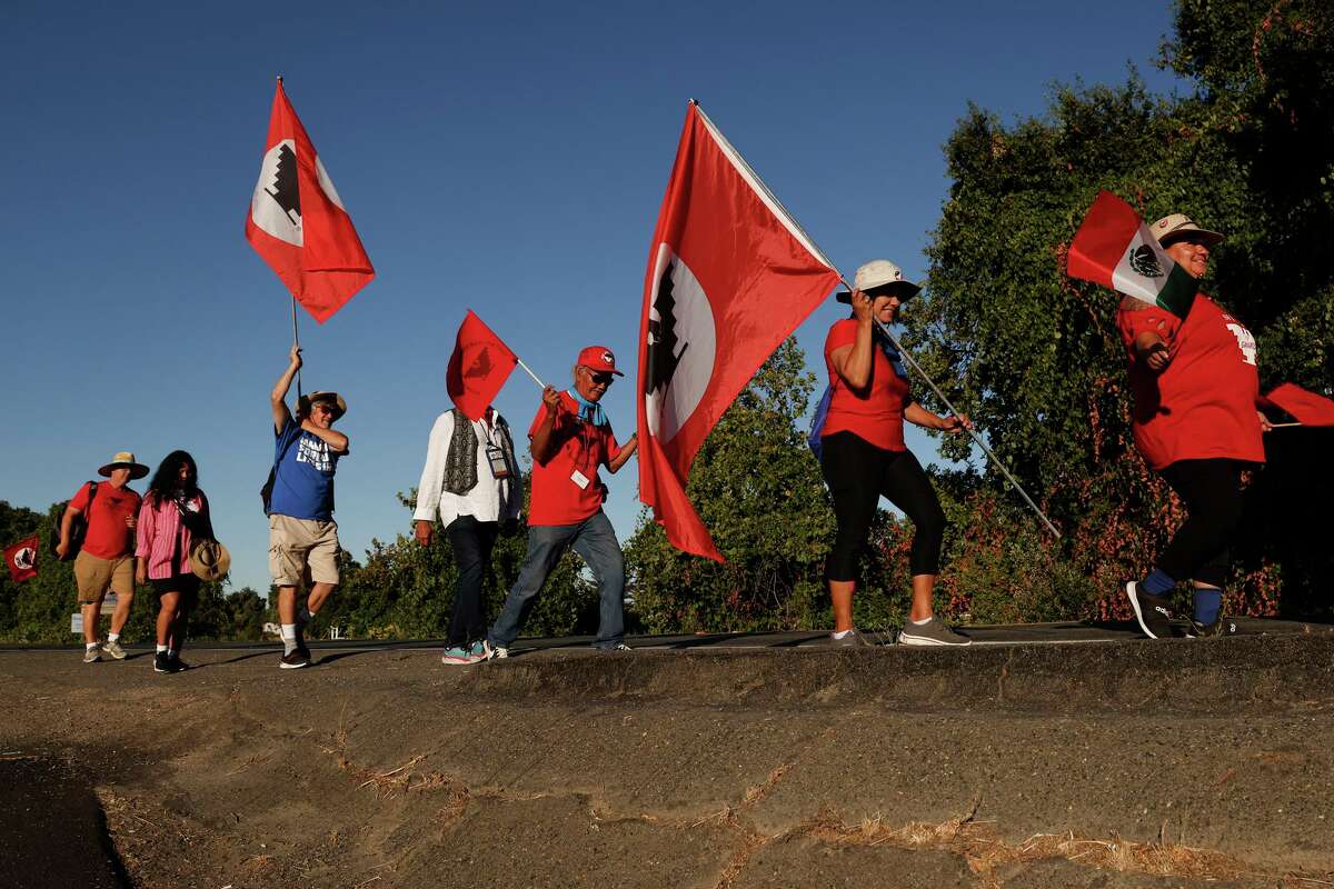 United Farm Workers members and supporters march along River Road toward Elk Grove on the 22nd day of their 335-mile walk to advocate for their cause to Gov. Gavin Newsom.