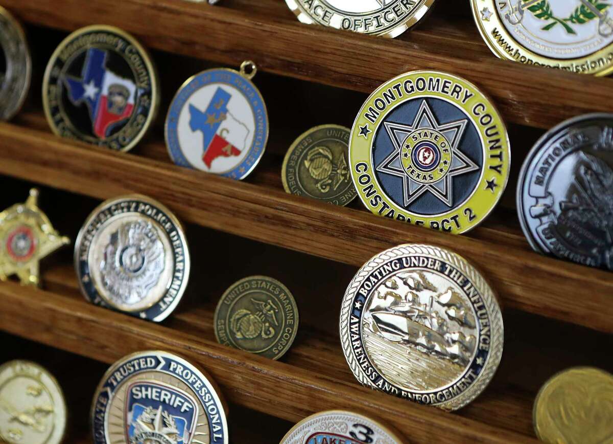 A collection of challenges coins are seen in Chief Deputy Don Fullen’s office, Friday, Aug. 26, 2022. Fullen, who has spend the last 39 years serving Montgomery County, began his career as a dispatcher in Alabama before moving to Texas in 1970 where he worked at Sam Houston State University as a part of its newly formed university police department. He later joined the Montgomery County Sheriff’s Office. In 1983, Fullen joined the Montgomery County Sheriff’s Department and named chief deputy for the Montgomery County Precinct 1 Constable’s Office in 2017.