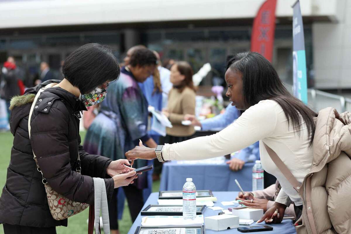 A job seeker meets with a recruiter at a career fair in San Francisco. Lifelong learning keeps workers’ skills current and prepares them for the next wave of opportunities.