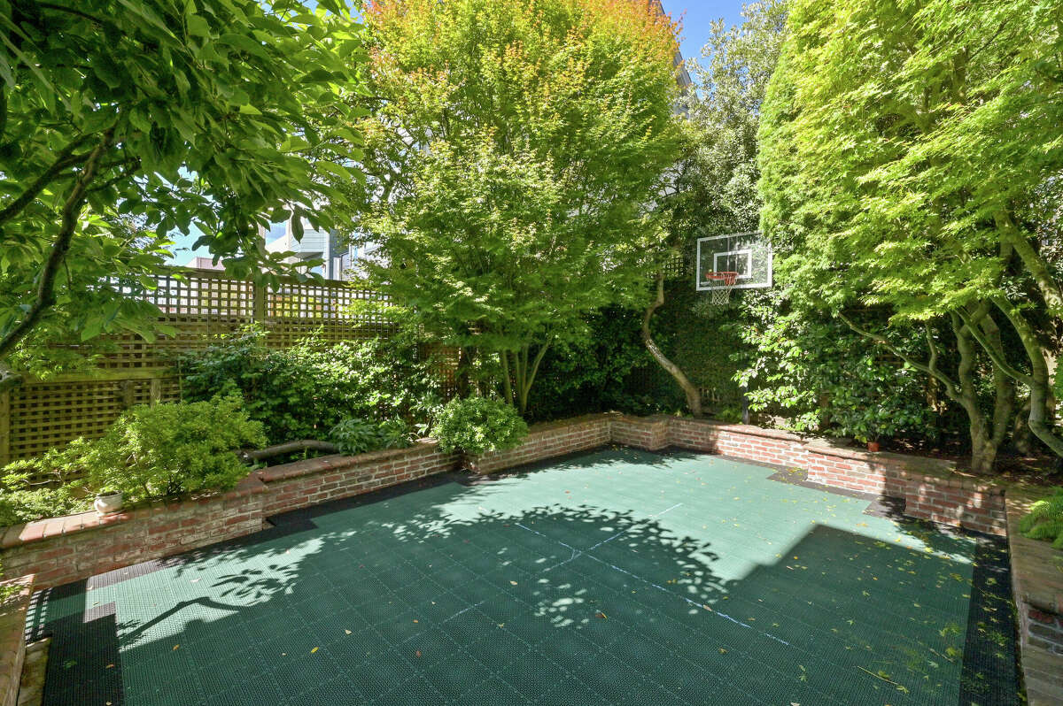 The backyard features a modular tiled sports court.