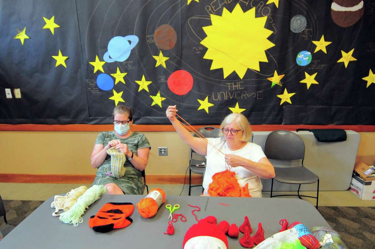 Susan McGovern, left, and June Ewing, with the Sit'n Stitch Knitting/Crocheting Group, work on their knitting projects at Cos Cob Library in Greenwich, Conn., on Tuesday August 23, 2022.