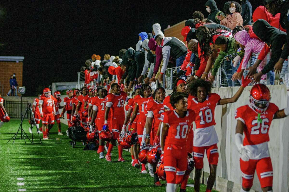 Manvel Mavericks fans celebrate with players during a 2021 game.