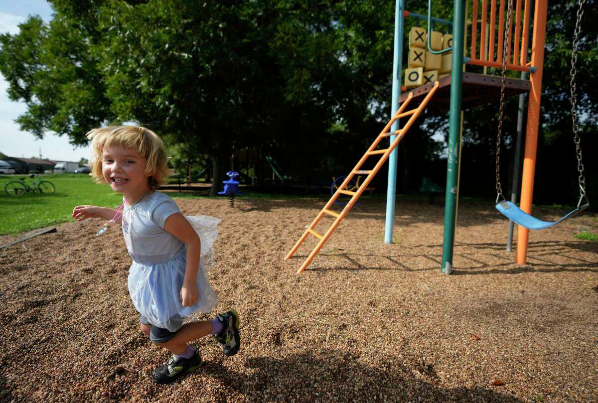 Allie Jordan, 3, with her mother, Sarah Jordan, plays in the Valley Lodge park along Cowhide Drive near FM 1093 Thursday, Aug. 25, 2022, in Wallis. The neighborhood park is next to the land that is proposed for a concrete batch plant on FM 1093 in Simonton.