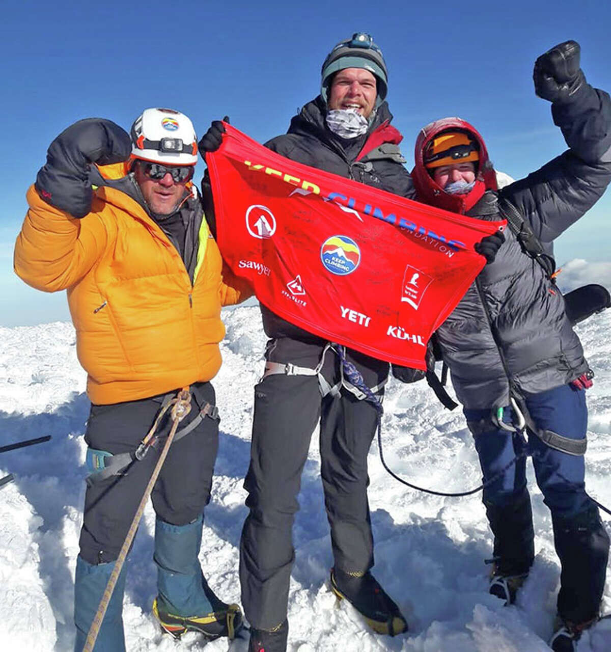 Edwardsville resident Lance McOlgan, left, Keith Austin, middle, and Brittany Oligney celebrate after reaching the summit of Chimborazo, the highest mountain in Ecuador, on Aug. 19 during the eighth annual Climb for the Kids, hosted by the Keep Climbing Foundation. Seven climbers were in their party. but they were the only ones to reach the top of the mountain.