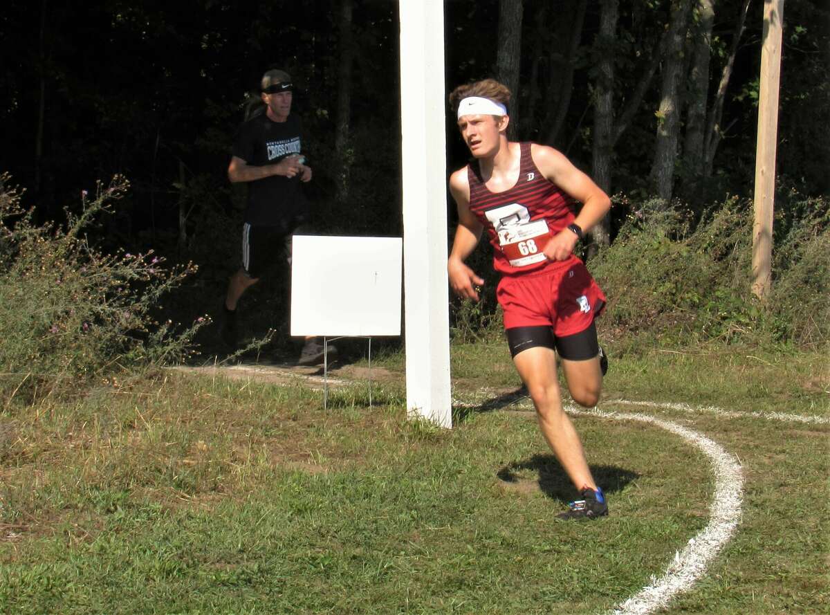 Onekama's Mason Sinke bolts through the final stretch of the course during the 2022 Pete Moss Invitational on Aug. 26 at Benzie Central High School.