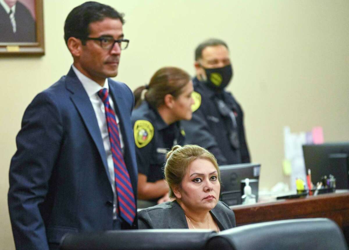 Defendant Michelle Barrientes Vela sits in court Thursday with her attorney, Nico LaHood. Vela is on trial, fighting tampering with evidence charges stemming from an accusation that she coerced a family into giving her $300 to reserve a park pavilion they had already paid for.
