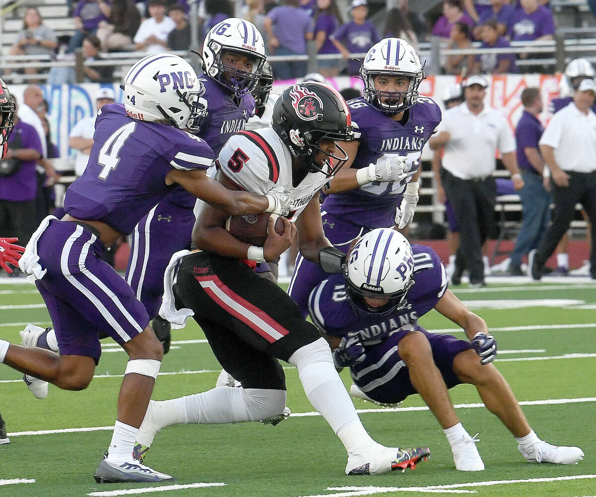 Port Neches-Groves' defense try to contain Port Arthur Memorial's Davion Wilson during their season opener Friday. Photo made Friday, August 26, 2022 Kim Brent/Beaumont Enterprise