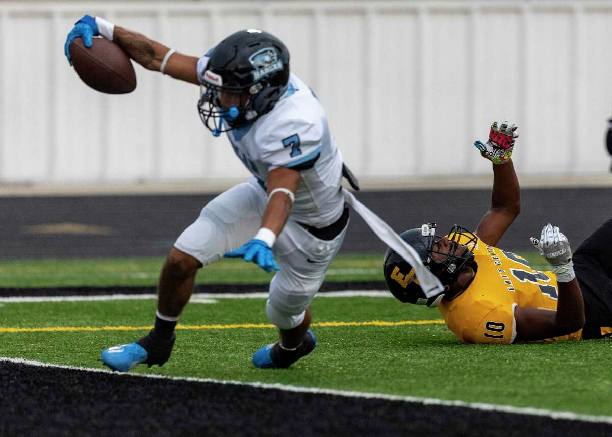 Harlan’s Jacob Gonzales stretches Friday night, Aug. 26, 2022 at East Central High School for a touchdown after a missed tackle by East Central’sMyron Robinson during the first half of the Hawks’ game against the Hornets.