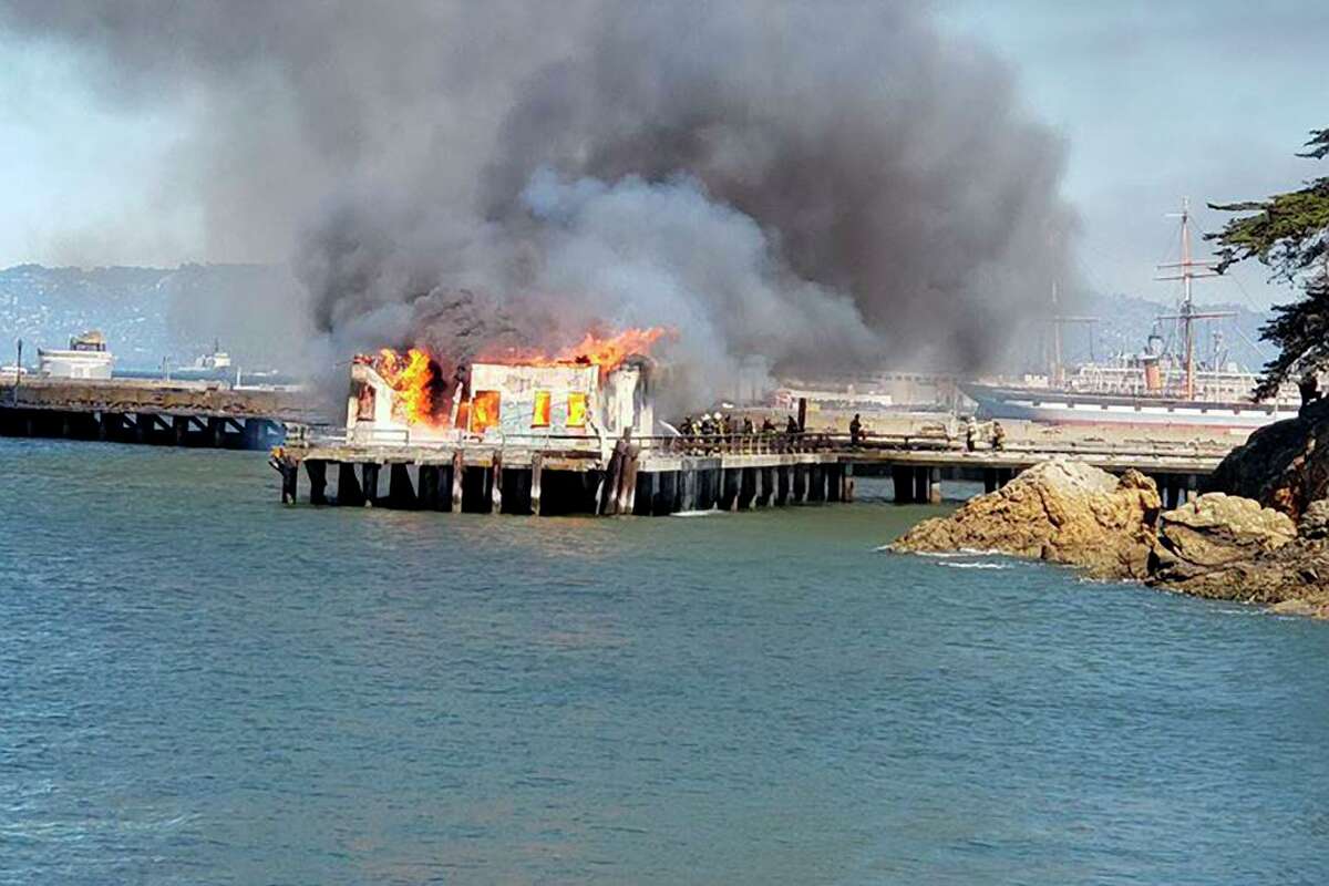Flames consume Fort Mason Pier 4, sending heavy smoke into the air this month.