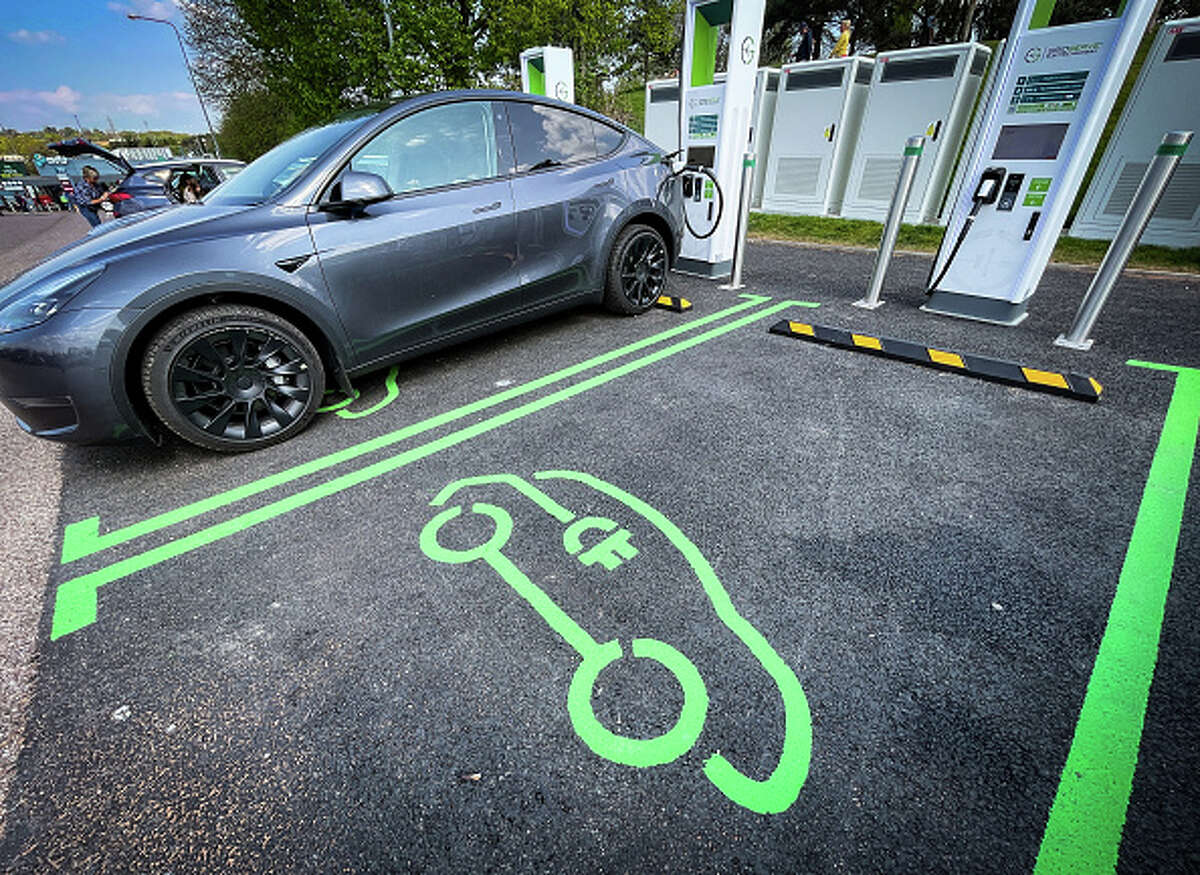 Electric cars are charged at a service station.