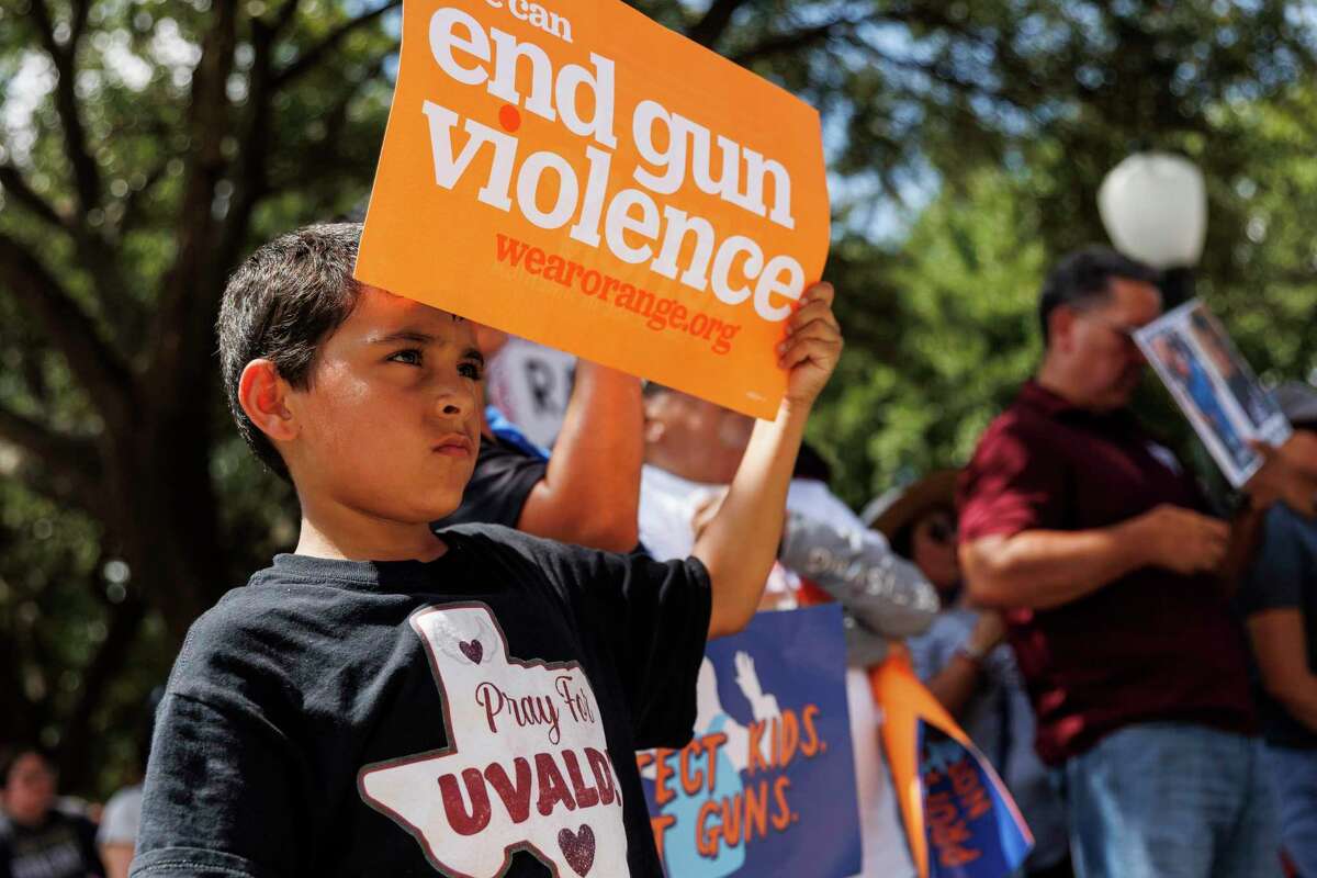 Jeremy Trevino, 10, listens to speakers during the Raise Our Voices to Raise the Age March for Our Lives Rally at the Texas State Capitol in Austin, Texas, Saturday, Aug. 27, 2022.