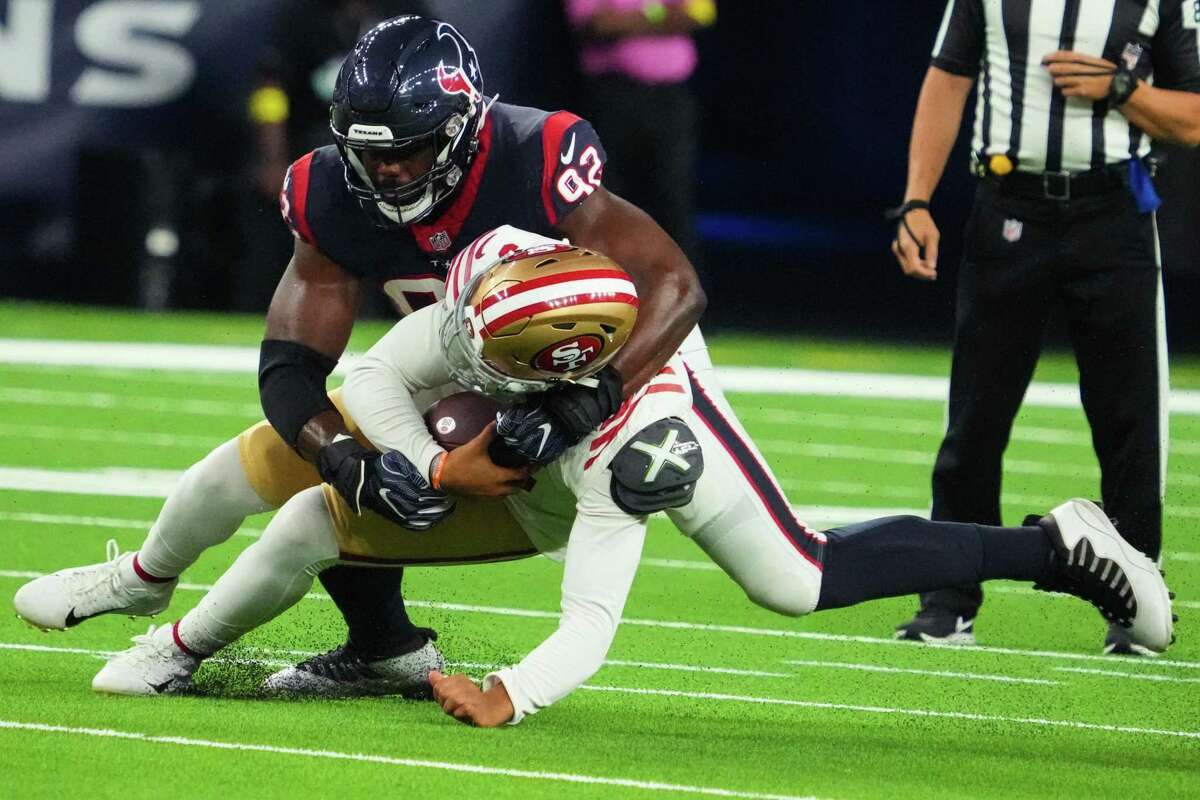Houston Texans defensive end Rasheem Green (92) sacks San Francisco 49ers quarterback Trey Lance (5) during the first half of an NFL football game Thursday, Aug. 25, 2022, in Houston.