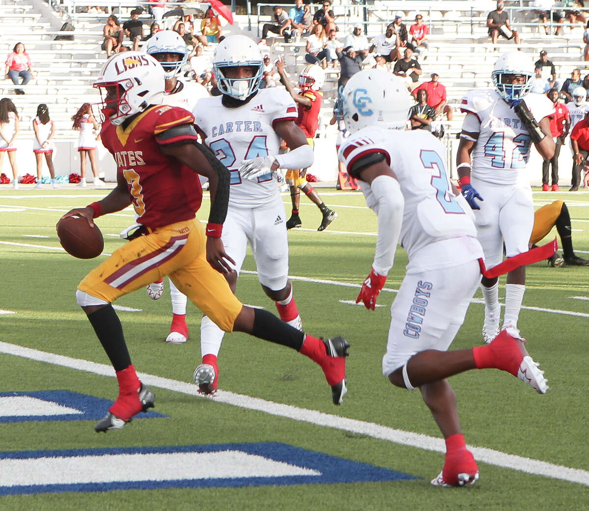 Yates quarterback Jaquan Brandon (3) runs for a 7-yard touchdown during the second quarter of a non-district high school football game at Delmar Stadium, Saturday, Aug. 27, 2022, in Houston.