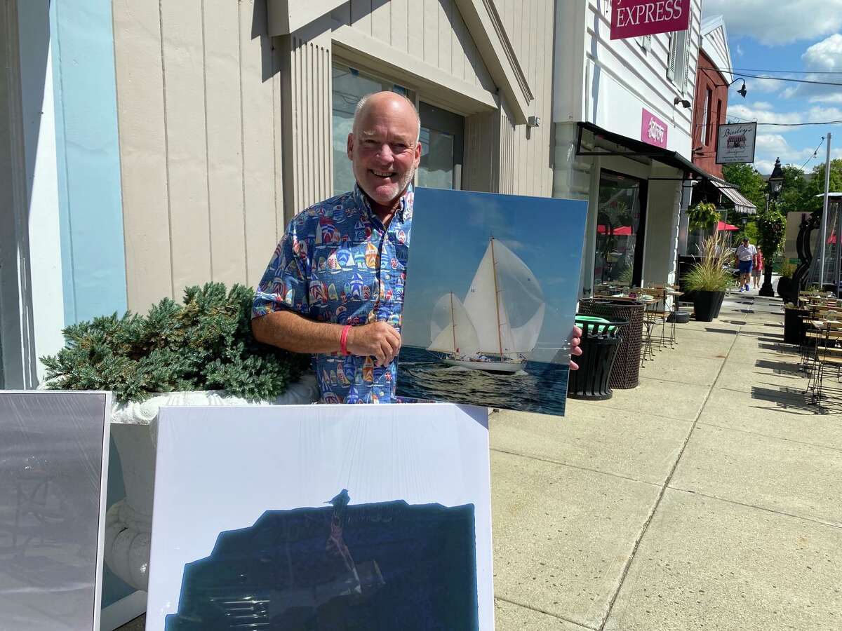 Rick Bannerot stands in front of his artwork