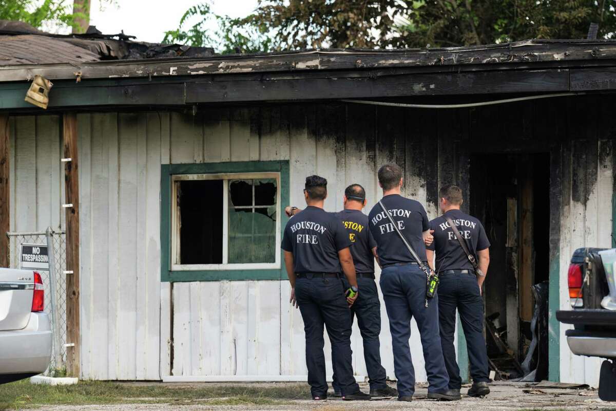 Firefighters investigate the scene of a burned out apartment building in the aftermath of a shooting that left four people dead Sunday, Aug. 28, 2022 in Houston. A longtime tenant facing eviction started several fires early Sunday in southwest Houston and then shot at residents as they fled the blaze, killing three before authorities fatally shot him, police said
