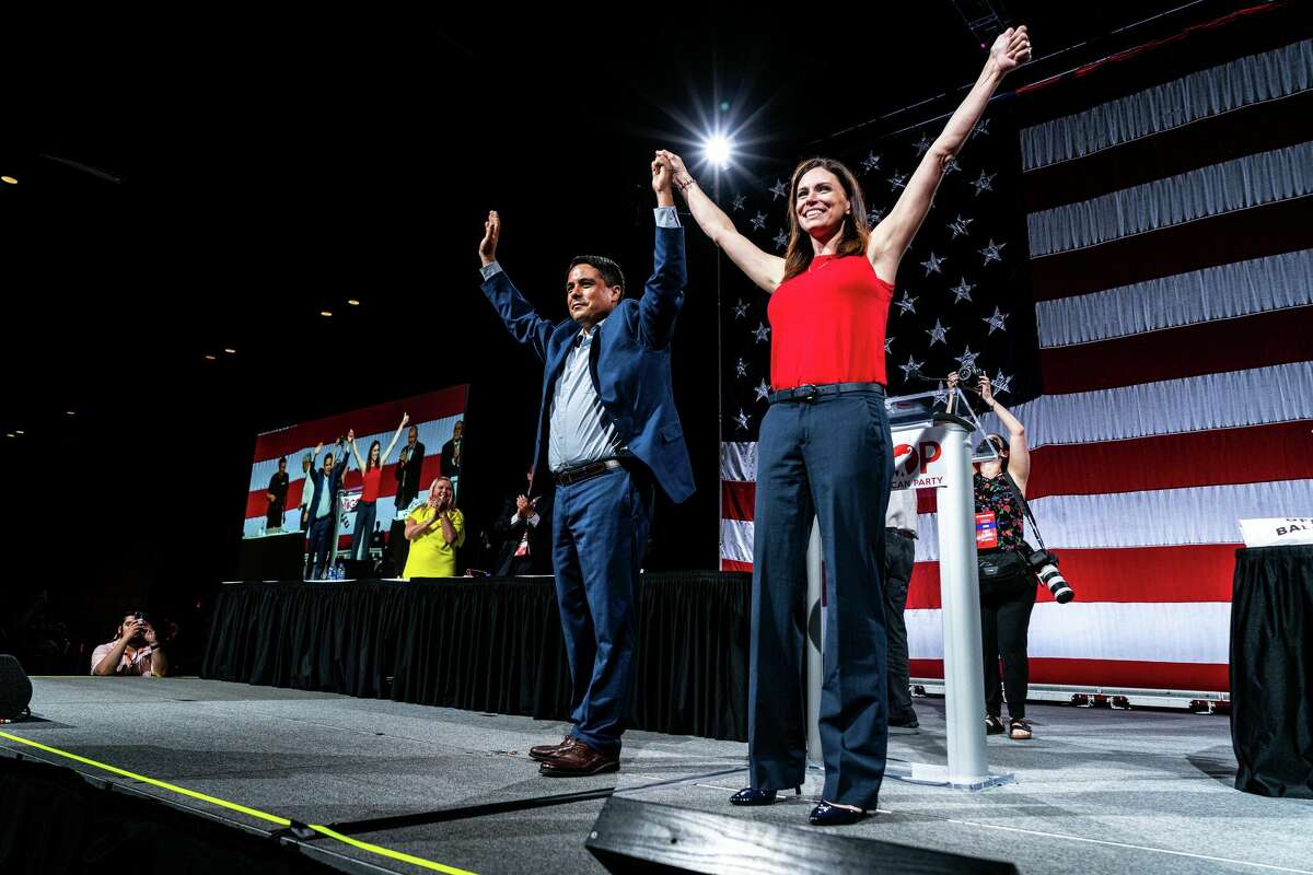 Michigan Republican Party lieutenant governor nominee Shane Hernadez and governor candidate Tudor Dixon take the state Saturday at the state convention in Lansing. 