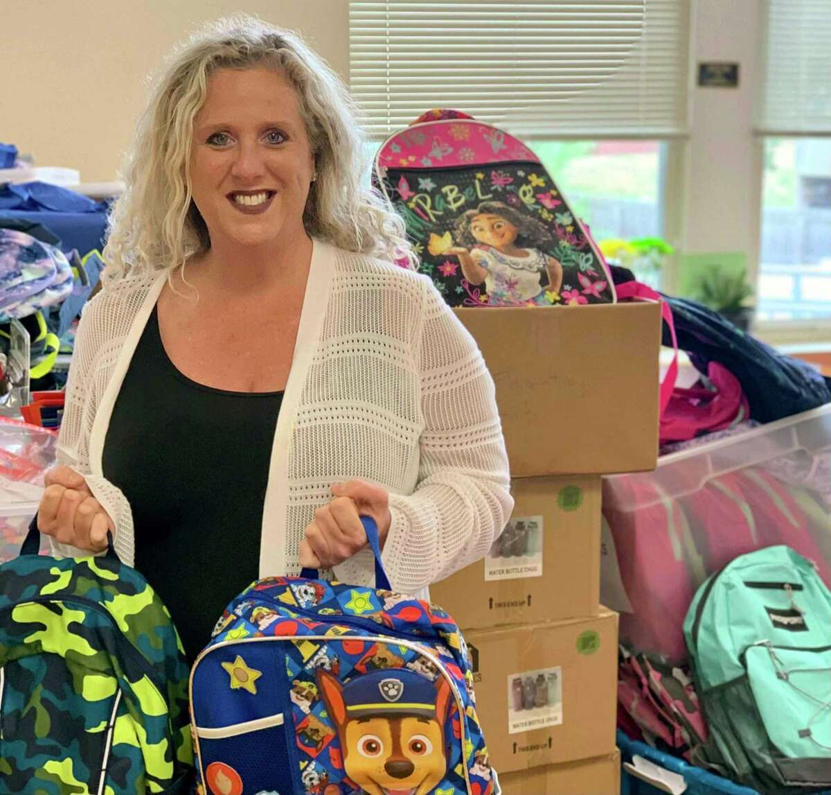 CDR program and outreach coordinator Andrea Savino with some of the 89 backpacks distributed at the Aug. 23 CDR Community Dinner at Branford’s Community House
