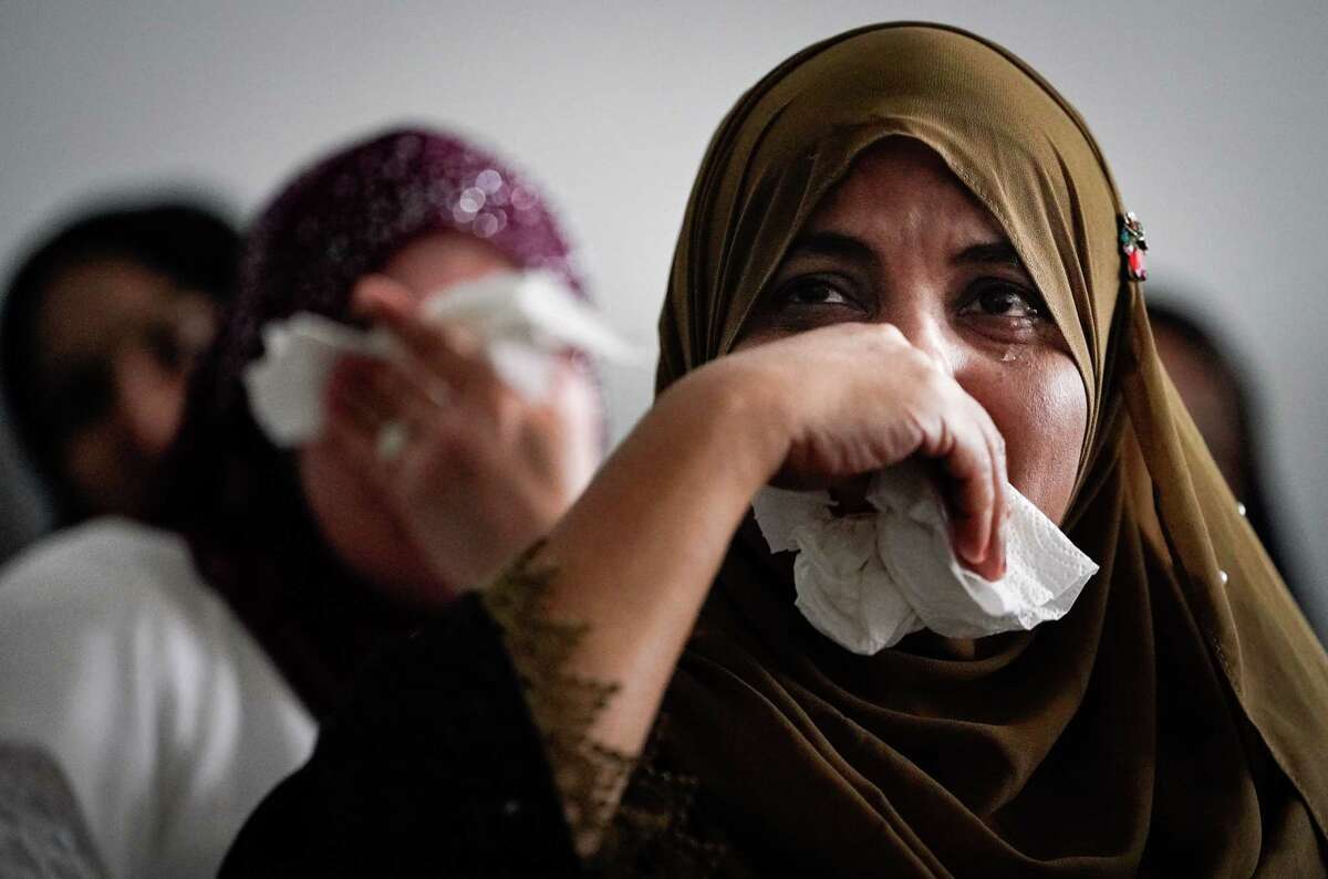 Hamidah Abdul Salam cries as she watches a video about the Rohingya genocide during a remembrance event Saturday, Aug. 27, 2022, in Houston. “I felt really hurtful when I saw my people being killed,” she said through a translator. “It pains me deep down in my heart, I can’t stand this situation.” She described being thankful to the American people and their government for welcoming them and giving them “an equal life.”