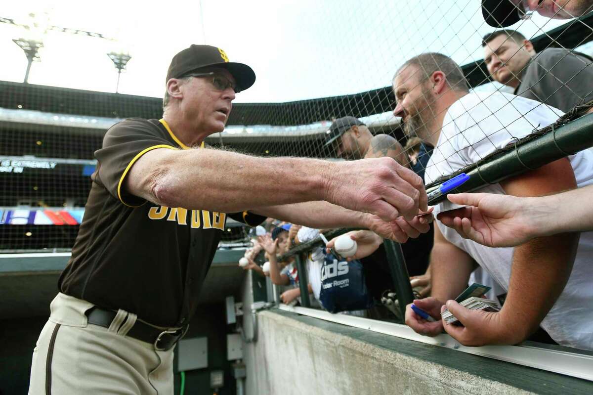 San Diego Padres manager Bob Melvin signs autographs for fans before a baseball game against the Detroit Tigers, Monday, July 25, 2022, in Detroit. (AP Photo/Jose Juarez)
