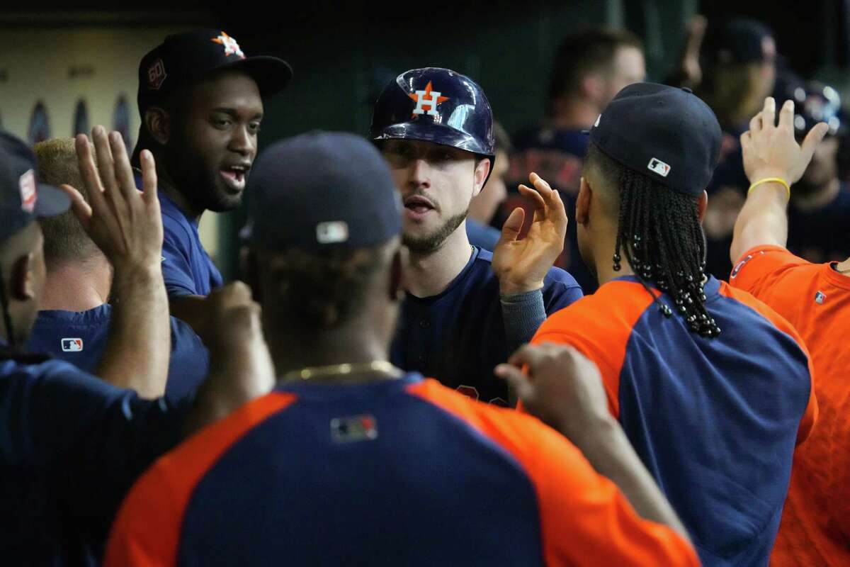Houston Astros right fielder Kyle Tucker high fives his teammates after scoring on Yuli Gurriel’s 2-run single against the Baltimore Orioles during the seventh inning of an MLB baseball game on Sunday, Aug. 28, 2022, in Houston.