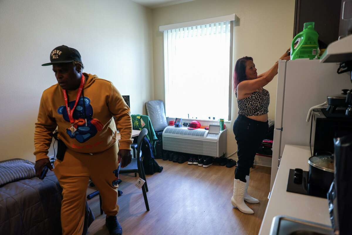 Lawrence Rickey Jones and wife Margarita Hernandez prepare to eat a meal inside Jones’ room at the Jazzie Collins Apartments. Jones, a former security guard, moved into the building in August after being homeless, while Hernandez is living in a homeless shelter with hopes of moving in with her husband. “I’m very happy,” Jones said. “It feels good to have your very little apartment and your own key to unlock your door, man. It’s a great feeling.”