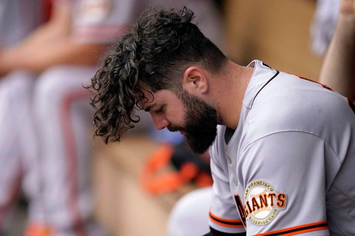 San Francisco Giants starting pitcher Jakob Junis reacts from the dugout after being removed during the fifth inning of a baseball game against the Minnesota Twins, Sunday, Aug. 28, 2022, in Minneapolis. (AP Photo/Abbie Parr)